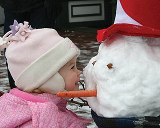 CLOSEUP: Jaime Hoefert, 2, is getting to know her new winter friend at Terrytown Gift shop in North Lima..