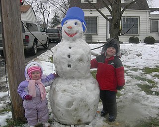 Landon and Lanie Joyce, ages 3 and 1, of Boardman, built their first snowman of the year with help from their mom and dad, Casie and David Joyce..