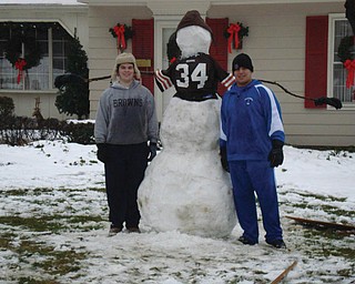 Cousins Zack Politsky, 16, and Nick Sebastian, 17, both of Poland and juniors at Poland High School, pose with a Browns snowman that was built over Christmas break in the Politsky front yard and was still standing tall at the time this picture was submitted to The Vindicator..