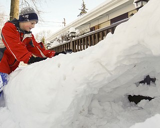 The Vindicator/Lisa-Ann Ishihara--- Tyler Evans (10) of Austintown packs more snow on top of the fort his father help him make.