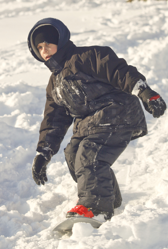 The Vindicator/Lisa-Ann Ishihara--- Dylan Ward (8) boards down the hill in the snow at Mill Creek Park's  Wick Recreation Area .