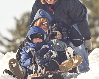 The Vindicator/Lisa-Ann Ishihara--- Tracy Ward of Girard gives her sister, Melissa Ward of Liberty, and nephews Evan (5) and Zach (3) a push down the hill in the snow at Mill Creek Park's Wick Recreation Area .