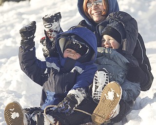The Vindicator/Lisa-Ann Ishihara--- Melissa Ward of Liberty, and sons Evan (5) and Zach (3) slide down the hill in the snow at Mill Creek Park's  Wick Recreation Area .