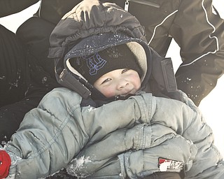 The Vindicator/Lisa-Ann Ishihara--- Zach Ward (3) of Liberty is all bundled up for sledding in the snow at Mill Creek Park's  Wick Recreation Area .