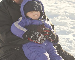 The Vindicator/Lisa-Ann Ishihara--- Danielle Mackall of Austintown holds Colin Bakos (3) after  sliding backwards down the hill in the snow at Mill Creek Park's  Wick Recreation Area .