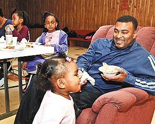 FAMILY AFFAIR: Youngstown 2nd Ward Councilman DeMaine Kitchen, right, enjoys Super Bowl 44 at a non-alcoholic, family-oriented party at Rising Star Baptist Church, with his family. From left are: Leslie, his wife, and their children, Savannah, 4, Olivia, 6, and Amber, 1.