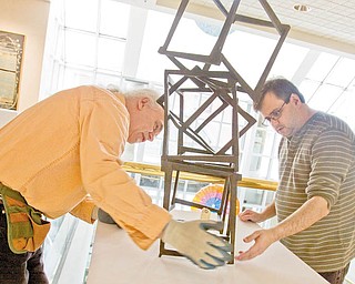 MEN AT WORK: Ed Hallahan, left, and Wayne Grover, workers at the Butler Institute of American Art on Wick Avenue, Youngstown, help stabilize Jedd Novatt’s artwork. The art museum is a good place to spend time on a Valentine’s Day date. The daily admission cost: free.