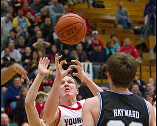The Vindicator/Geoffrey Hauschild.YSU's Vytas Sulskis (44) reaches for a rebound while blocked by Butler's Zach Hahn (3) and Gordon Hayward (20) during the second half of a game at YSU's Beeghley Center on Thursday evening.