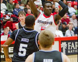 The Vindicator/Geoffrey Hauschild.YSU's Sirlester Martin (5) looks for the open man during the second half of a game at YSU's Beeghley Center on Thursday evening.