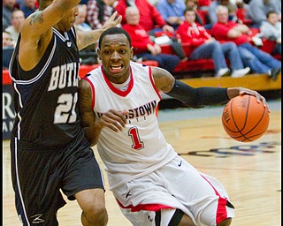 The Vindicator/Geoffrey Hauschild.YSU's DeAndre Mays (1) drives to the hoop while defended by Butler's Willie Veasley (21)  during the second half of a game at YSU's Beeghley Center on Thursday evening.
