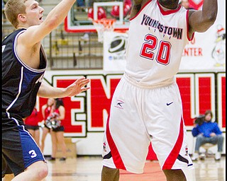 The Vindicator/Geoffrey Hauschild.YSU's Ashen Ward (20) looks for the open man while defended by Butler's Zach Hahn (3) during the second half of a game at YSU's Beeghley Center on Thursday evening.