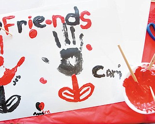 A DIFFERENT TAKE: Audra Dull, 15, of Niles, gave her opinion of the holiday in this painting, created during Thursday’s party. Contrary to the theme of the Anti-Valentine’s Day event, she said she considers the Feb. 14 observance “cool.”