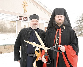 WELCOMING COMMITTEE: Father Anthony and Bishop Timothy cut the ribbon Thursday at the Monastery Inn in Canfield. The monastery is the former Canfield Colonial Motel and was purchased by monks from the Syro-Russian Orthodox Catholic Church who moved from the West Side of Cleveland. It includes short and long-term accommodations, a bookstore and gift shop and will eventually have a retreat center.