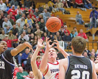 UNDEFEATED BULLDOGS: Youngstown State’s Vytas Sulskis (44) grabs for a rebound while being blocked by Butler’s Ronald Nored (5), Zach Hahn (3) and Gordon Hayward (20) during the second half of Thursday’s game at YSU’s Beeghly Center. The Penguins lost another one to the Bulldogs, who with the 68-57 win remain undefeated in the Horizon League. 
