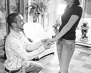 Special to the Vindicator
BE MY VALENTINE: Despite the recent snowstorm, Brock Glass, a teacher at Mahoning County High School in Youngstown, persuaded Megan Kennedy, an art major at Slippery Rock University, to brave the elements and travel to Columbiana for a tour of Roberta’s Gallery of Fine Art. After visiting the gallery, the owner, Roberta Myers, invited the New Castle couple to view a private collection of art at her home. While in the garden room, Brock dropped to his knee and proposed to the surprised Megan before placing a ring on her finger. Coming out of hiding to share the excitement were the couples’ parents, who had helped plan the engaging moment.
