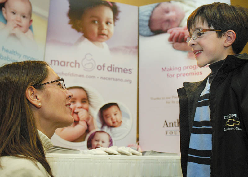 ALL SMILES: March of Dimes 2010 national ambassador, Joshua Hoffman of Weston, Fla., got some pointers from his mother, Melanie, on the speech he was about to deliver Tuesday to the MOD Mahoning Valley March for Babies Leadership Luncheon.