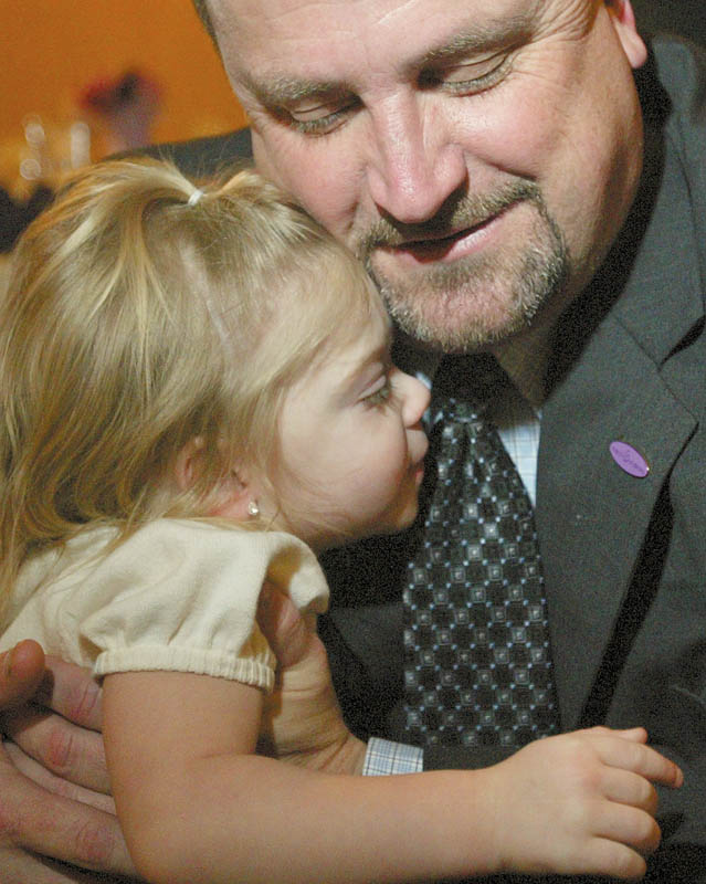 SPECIAL MOMENT: Olivia Reichard of Youngstown gets a hug from Scott Sterneckert, director of the MOD’s North East Ohio Division. Olivia and her sister, Maria, are the 2010 MOD Mahoning Valley ambassadors.