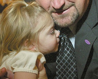 SPECIAL MOMENT: Olivia Reichard of Youngstown gets a hug from Scott Sterneckert, director of the MOD’s North East Ohio Division. Olivia and her sister, Maria, are the 2010 MOD Mahoning Valley ambassadors.