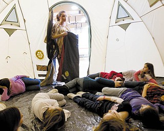 SHOW AND TELL: Fourth-grade teacher MeLynda Guerrieri holds a sleeping bag and speaks to her students at C.H. Campbell Elementary in Canfield as they lie inside a tent such as the ones that are being shipped to Haiti in shelter boxes. Students from C.H. Campbell and Hilltop Elementary raised more than $8,500 and donated it to Canfield Rotary to assemble the disaster-relief kits for people in Haiti.
