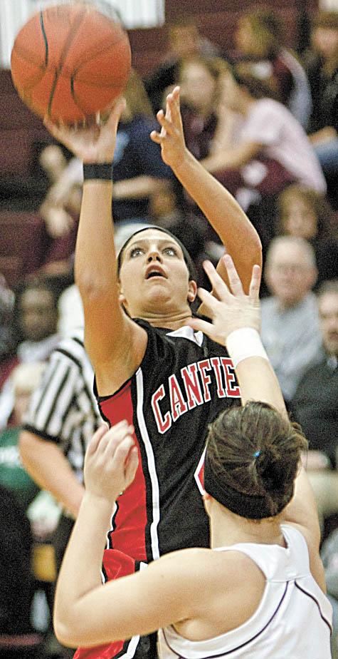 The Vindicator/Geoffrey Hauschild.Canfield's  Jillian Halfhill (4) shoots past Boardman's Missy Demarinis (20).during the third quarter of a game at Boardman High School on Thursday evening.
