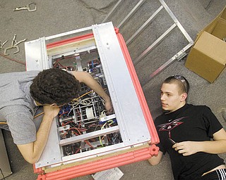 ROBOTIC PROGRAMMING: Girard High School students Adam Biddle, 17, left, and Jordan Cole, 16, work on programming their team’s robot for its upcoming robotics competition.