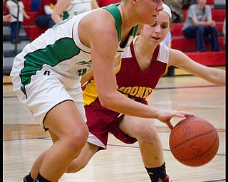 The Vindicator/Geoffrey Hauschild.West Branch's Michele Sosnick (30) dribbles down court while defended by Mooney's Angela Stana (15) during the third quarter of a game at Autintown Fitch High School on Wednesday evening.