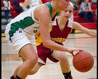 The Vindicator/Geoffrey Hauschild.West Branch's Michele Sosnick (30) dribbles down court while defended by Mooney's Angela Stana (15) during the third quarter of a game at Autintown Fitch High School on Wednesday evening.