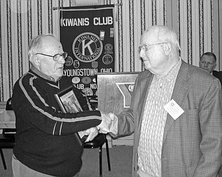Special to the Vindicator
END OF ERA: Celebrated during the Feb. 19 luncheon meeting of the Kiwanis Club of Youngstown was the discovery of the time capsule buried in 1921 at The Rayen School and the end of the football rivalry that once existed between South High School Warriors and the Rayen Tigers. To emphasize the importance of the events, Chuck Whitman, a Kiwanian and president of South High School Alumni Association, at left, presented a framed copy of The Vindicator article on the time capsule to Charles Rudibaugh, a Kiwanian and president of the Rayen trustees. Those present agreed to continue to support Youngstown City Schools with scholarships and financial aid.
