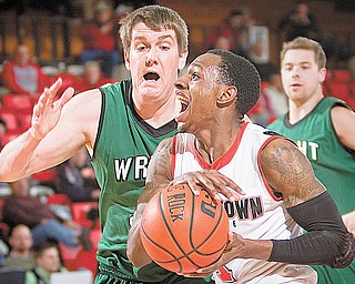 DRIVING POINTS: YSU’s DeAndre Mays (1), under pressure from Wright State’s Ronnie Thomas (40), drives for a layup during the second half of Thursday’s game at YSU’s Beeghly Center. The Raiders edged the Penguins, 76-73.