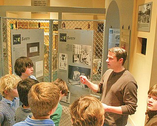 William D. Lewis/The Vindicator Henry Himes a YSU grad student an intern at the steelmuseum conducts a tour.,Student from the University School in Shaker Hgtstake a tour of the Steel Museum. students from the school visit the museum each year.