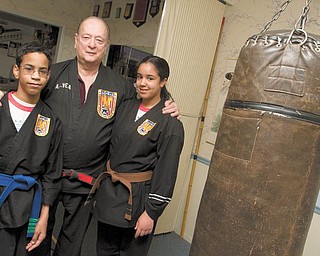 KARATE KIDS: Ben Powell, 13, and his sister Heather Powell, 17, take Karate lessons from A.E. Vea, 72, at his Karate studio on Belmont Avenue in Liberty. Ben Powell has cerebral palsy, a motor condition described as a group of disorders that can involve brain and nervous system functions such as movement, learning, hearing, seeing and thinking, and Vea said he gets satisfaction watching his student’s progress.