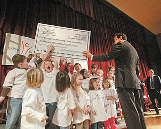 SUCCESS STORY: Kindergarten students at South Range Elementary School ham it up with U.S. Rep. Tim Ryan as they help him hold up a mock $100,000 check. Ryan presented the check to the United Way of Youngstown and the Mahoning Valley to expand its “Success by 6” program. The ceremony was Monday at the North Lima school, one of two Mahoning County schools to house the Success by 6 pilot program.