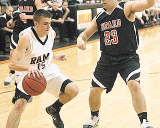 GIRARD - MINERAL RIDGE - (15) Zachary Kiger tries to drive as (23) Joe Augustine plays defense during their game Monday night. - Special to The Vindicator/Nick Mays