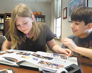 Poland North Elementary fourth graders Paige Kellgren and Julian Diaz, both 10, look over their recycling-themed scrapbook. The scrapbook is part of the school’s submission to the Disney’s Planet Challenge contest.