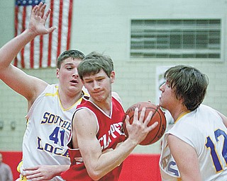 The Vindicator/Geoffrey Hauschild.Columbiana's Nick Good (30) drives through Southern Local's Jake Boyle (41) and Gabriel Martins (12) during the third quarter of the game at Struthers High School on Wednesday evening.