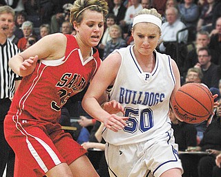 POLAND - SALEM - (50) Leanna Yeager of Poland drives to the hoop as (35) Amy Scullion plays defense during their game Thursday night in Austintown.