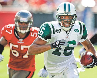 New York Jets wide receiver Brad Smith (16) outruns Tampa Bay Buccaneers linebacker Adam Hayward (57) for a first down on a wildcat play during the first quarter of an NFL football game Sunday, Dec. 13, 2009, in Tampa, Fla.