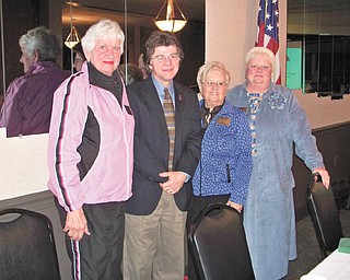 The functions and services provided by the Trumbull County Lifelines to make community life healthier were explained by John Myers, director of the organization, second from the left, when he spoke at the January meeting of Warren Republican Women’s Club. Joining the speaker at the event at DiLucia’s Banquet Room were, from left, Paula Snyder, secretary; Carol Griffiths, president; and Cary Ann Koren, second vice president of the club.