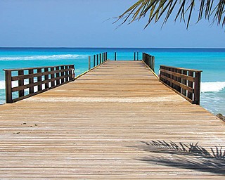 Karen Hum of Canfield won first place at the Canfield Fair with this photo taken at Grand Turk. She says she calls it ÒThe InvitationÓ because it makes the water look so inviting to just run and jump in.