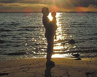 Jonathan Caguiat of Boardman, 43, is holding his son, Max,, 1, in Charlevoix, Mich..