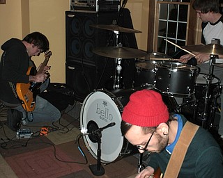 Braille bassist Josh Good, 28, of Boardman, far left, and guitarist Anthony Cucitrone, 22, of Boardman, manipulate their music with effects pedals, while drummer Ian James, 23, of Boardman, keeps the beat.