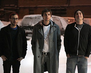 Standing outside the Lemon Grove on a recent Friday night are, from left, Anthony Cucitrone, 22; Ian James, 23; and Josh Good, 28, all of Boardman, Their band, Braille, performed at the Bonfrog Hibernation Revival Festival at the café.