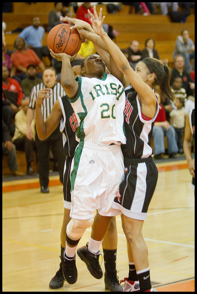 Geoffrey Hauschild|The Vindicator.Ursuline's Jasmine Brown (20) takes aim at the hoop wile defended by Campbell's Tashira Uceta (1) during the second quarter at Mineral Ridge High School on Saturday afternoon.