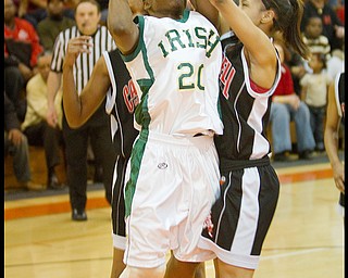 Geoffrey Hauschild|The Vindicator.Ursuline's Jasmine Brown (20) takes aim at the hoop wile defended by Campbell's Tashira Uceta (1) during the second quarter at Mineral Ridge High School on Saturday afternoon.