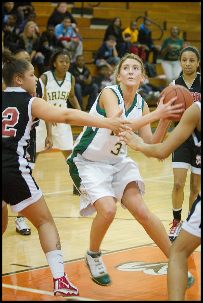 Geoffrey Hauschild|The Vindicator.Ursuline's Allison Naples (31) makes her way to the hoop while being defended by Campbell's Naja Thomsas (32 left) and teamates during the second quarter at Mineral Ridge High School on Saturday afternoon.