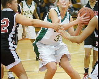 Geoffrey Hauschild|The Vindicator.Ursuline's Allison Naples (31) makes her way to the hoop while being defended by Campbell's Naja Thomsas (32 left) and teamates during the second quarter at Mineral Ridge High School on Saturday afternoon.