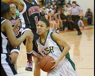 Geoffrey Hauschild|The Vindicator.Ursuline's Aurielle Irizarry (5) drives to the net past Campbell's Tashira Uceta (1) during the third quarter at Mineral Ridge High School on Saturday afternoon. Irizarry was ultimately fouled but made two of two free throws.
