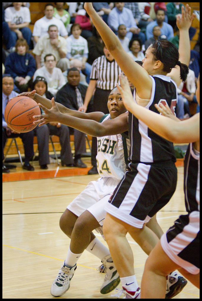 Geoffrey Hauschild|The Vindicator.Ursuline's Briana Curd (24) keeps the ball at a safe distance from Campbell's Tiffany Colon (25) while driving to the basket during the third quarter at Mineral Ridge High School on Saturday afternoon.