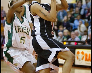 Geoffrey Hauschild|The Vindicator.Campbell's Tashira Uceta (1) successfully makes a layup while trailed by Ursuline's Dominique Jenkins (15) during the fourth quarter at Mineral Ridge High School on Saturday afternoon.