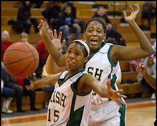 Geoffrey Hauschild|The Vindicator.Ursuline's Dominique Jenkins (15) and Courtney Powell (32) watch helplessly as the ball is knocked out of bounds during the fourth quarter at Mineral Ridge High School on Saturday afternoon.